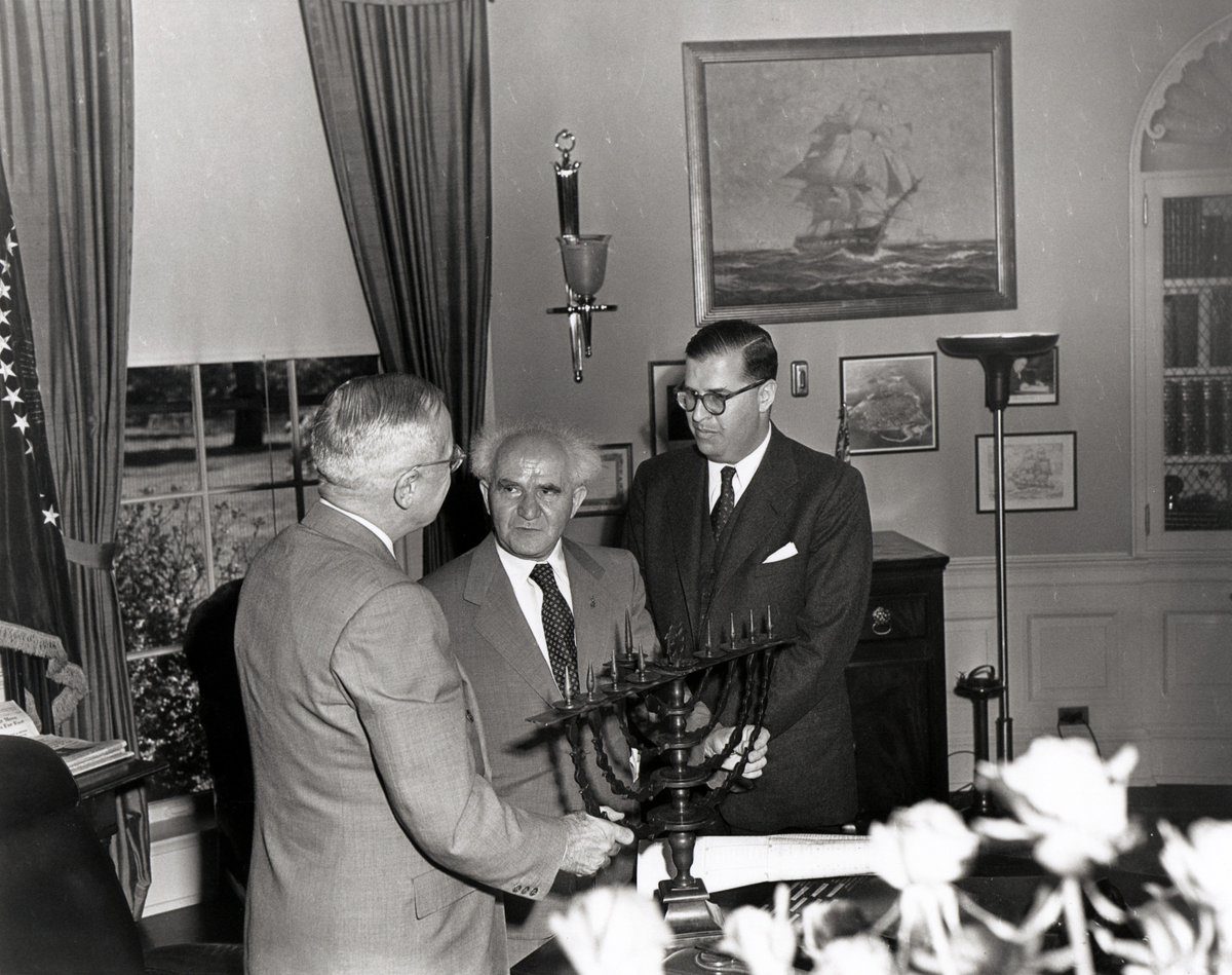 President Truman receiving a menorah from Israeli Prime Minister David Ben-Gurion, with Ambassador Abba Eban at right