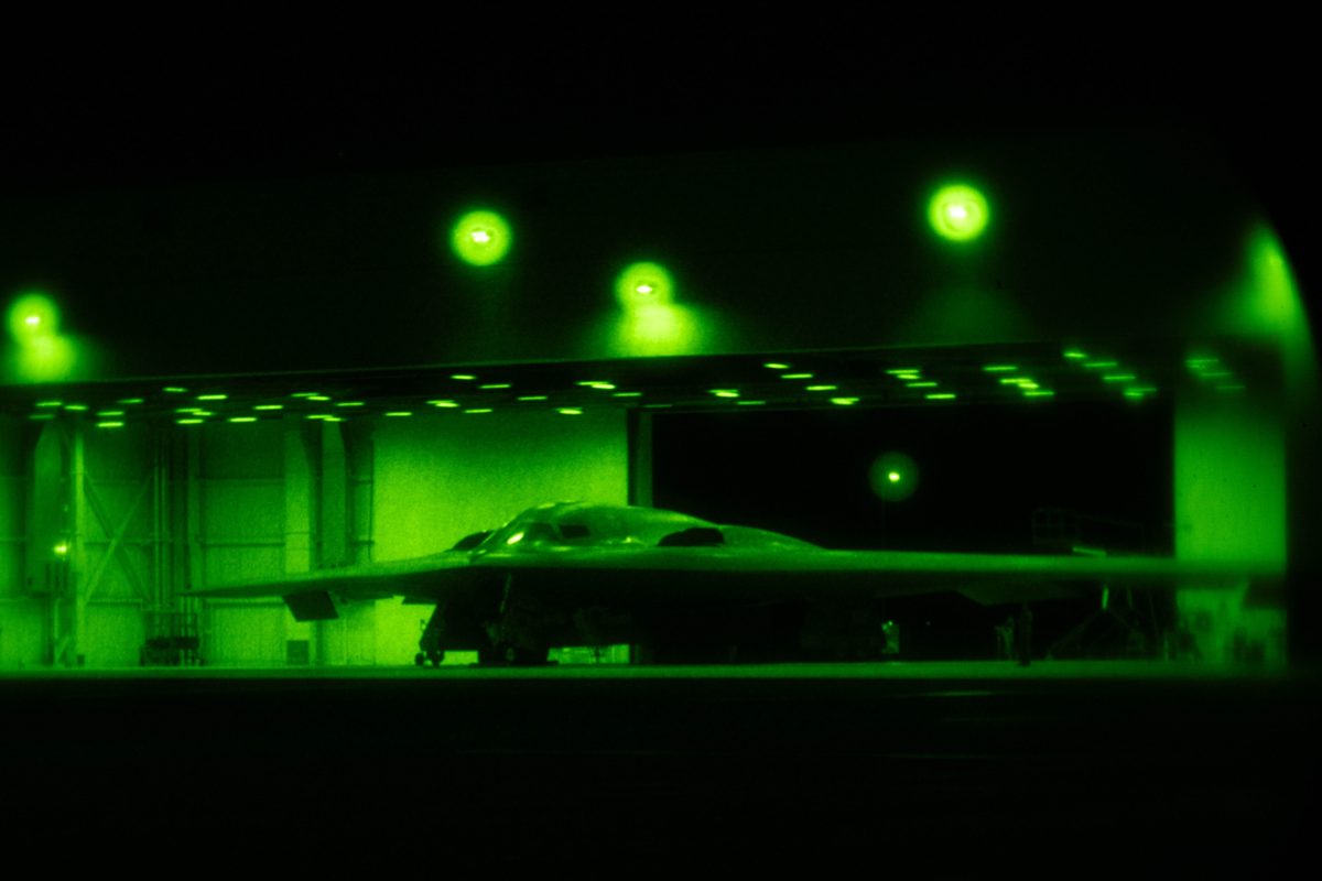 A B-2 stealth bomber in its hangar, seen through night-vision